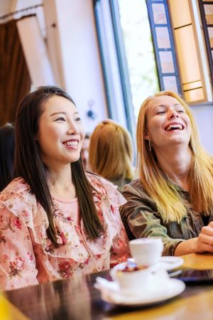Multiethnic friends talking in cafe