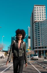 Woman with afro hair walking through the streets