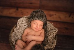 Naked baby sleeping in bucket