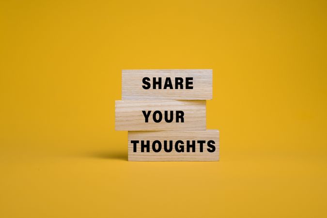 share you thoughts on wooden blocks isolated on orange background