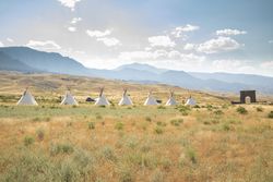 Montana, United States - August 17, 2022: Teepees in front of mountains in Yellowstone National Park