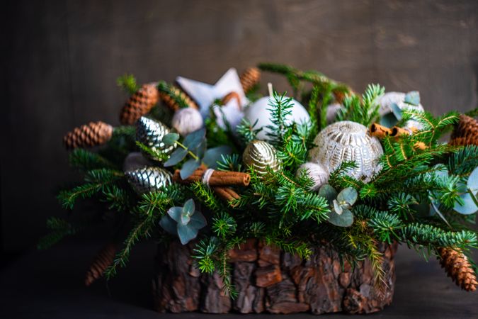 Wooden Christmas center piece topped with pine and ornaments