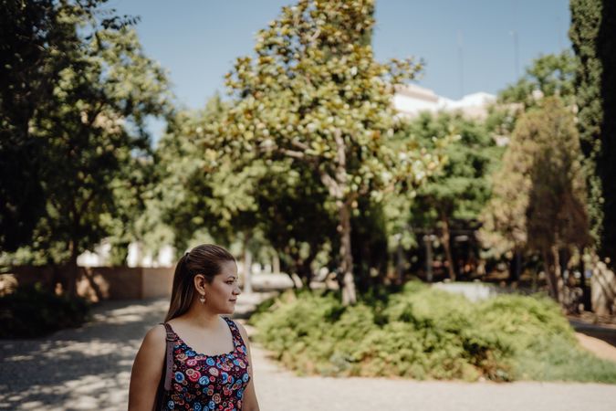 woman looking away walking at park