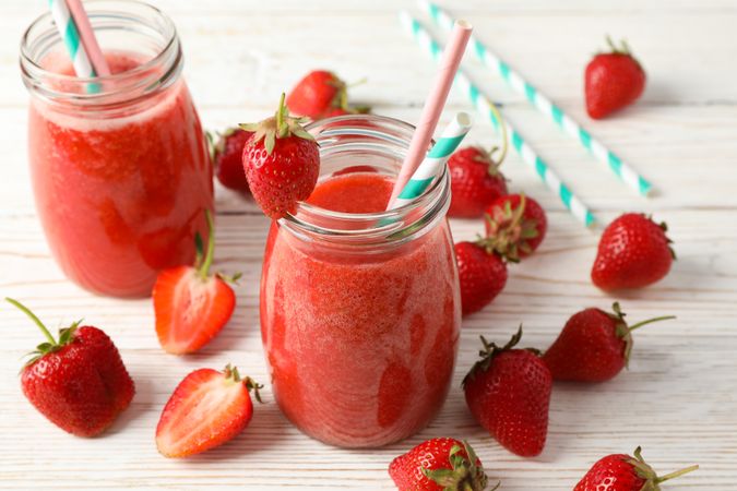 Composition with strawberry cocktails on wooden table. Summer berry
