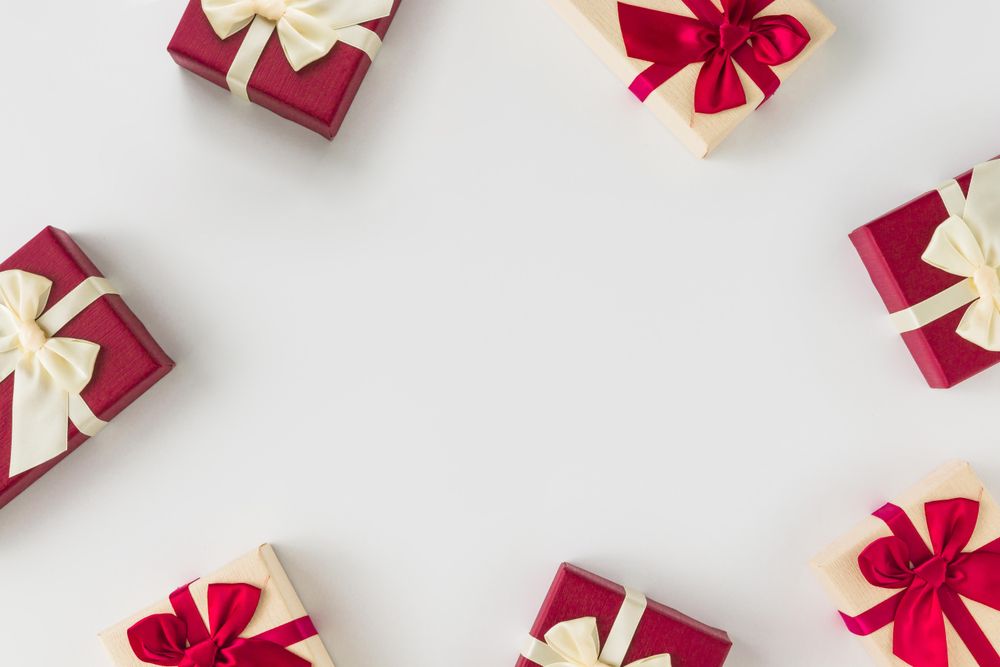 Red gift boxes wrapped in ribbon on light background