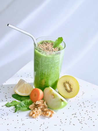 Smoothie with seeds near fruits