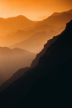 Brown mountains under sunset sky
