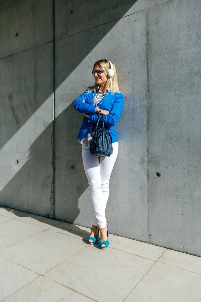 Businesswoman with headphones posing