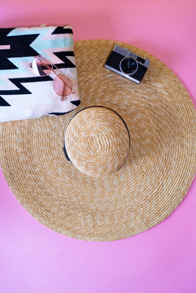 Summer trendy sunglasses, towel, hat and camera