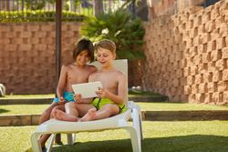 Boys using tablet in garden