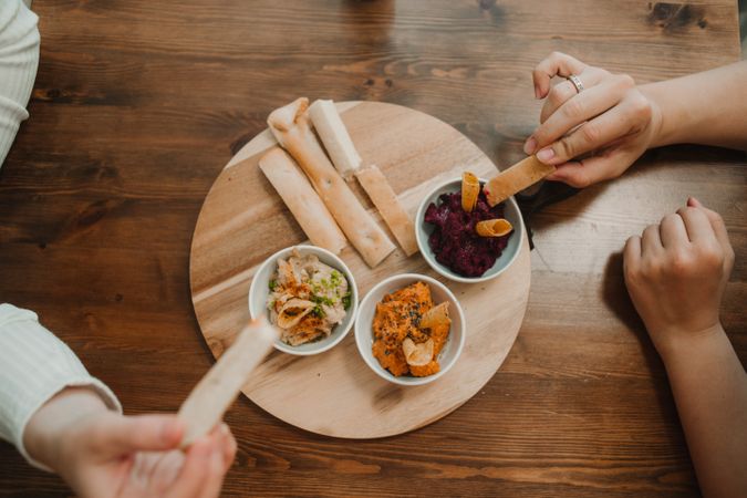 Different tasty sauces on round wooden stand
