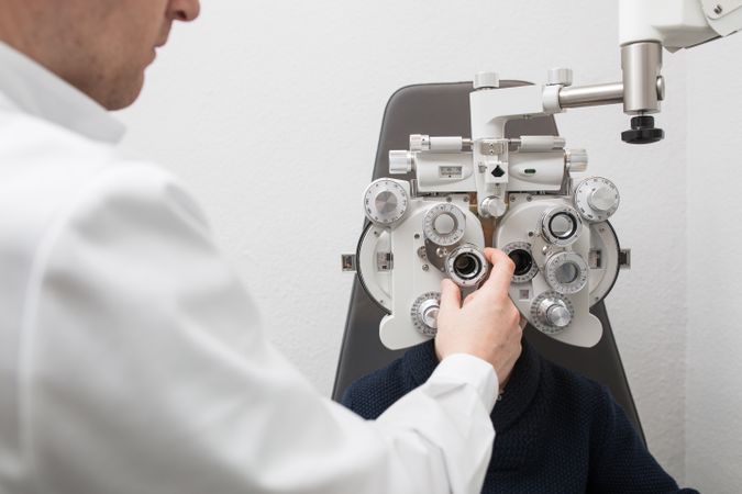 Optician testing a boy's eyes
