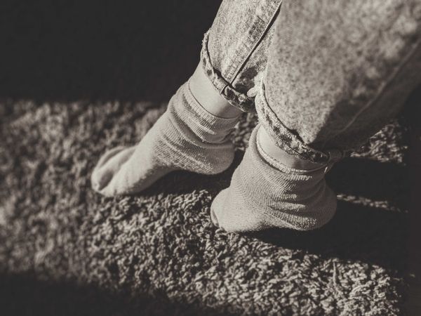 Grayscale photo of person wearing socks