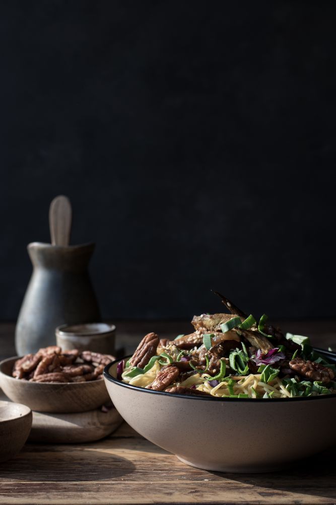 Miso noodles with egg plants and shiitake in bowl on table