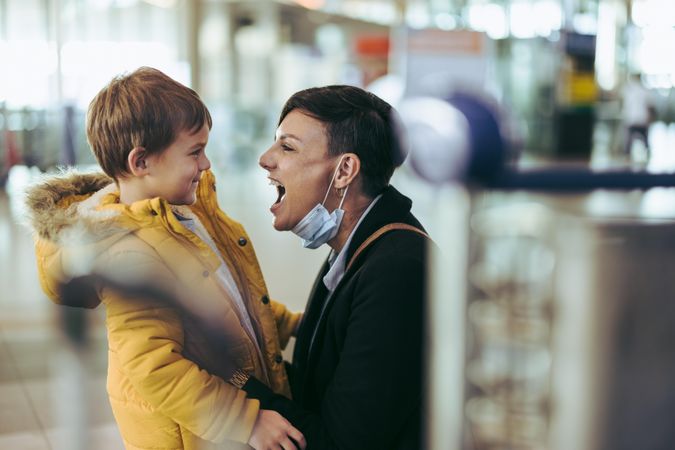Excited woman meeting her son at airport