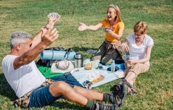 Father winning card game during a picnic