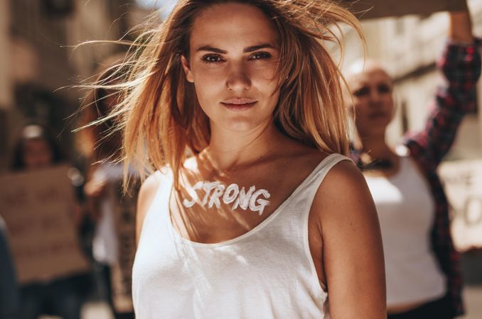 Woman with word strong written on her body