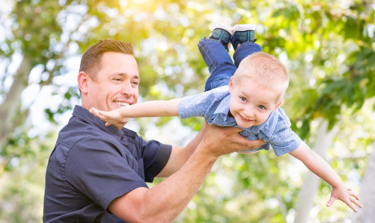 Young Father and Son Having Fun At The Park