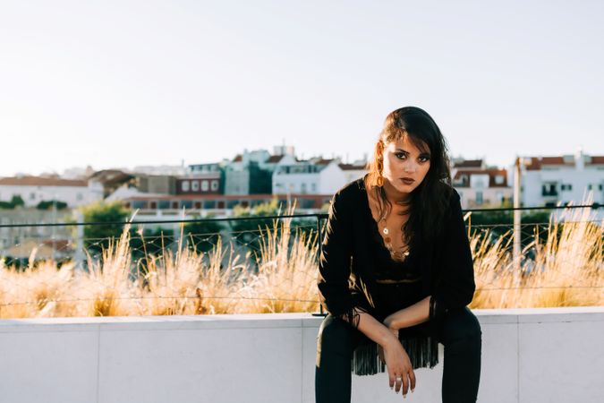 Trendy female standing on urban background