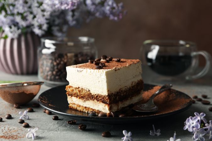 Composition with tasty tiramisu and lilac. Delicious dessert
