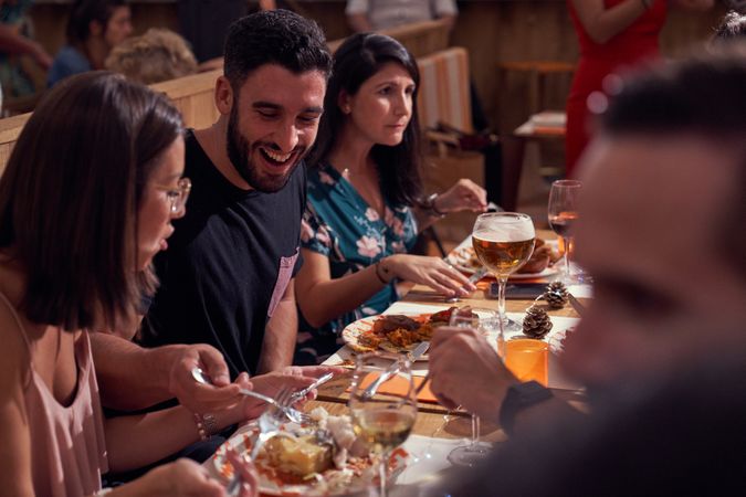 Cheerful friends eating in restaurant