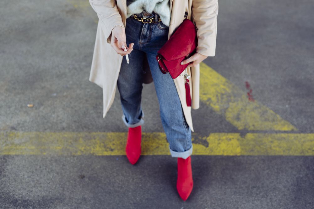 Young stylish woman standing on street road