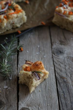 Pieces of fresh focaccia on wooden table