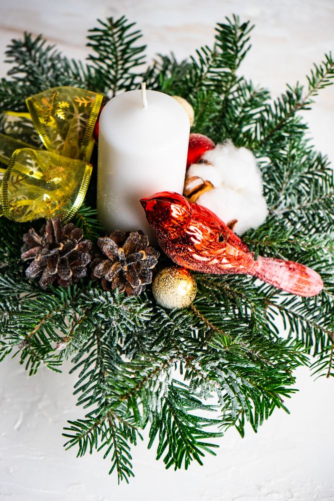 Christmas table concept with candles and spice decor on rustic background with copy space