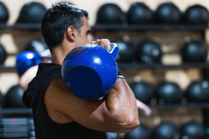 Strong man exercising with heavy weight