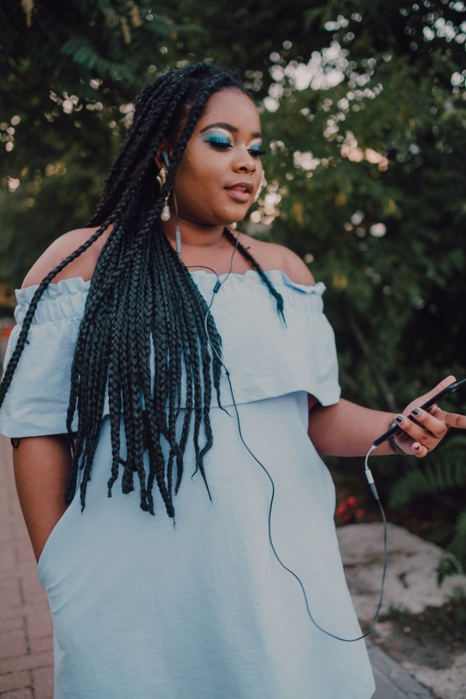 Happy trendy Black woman in park