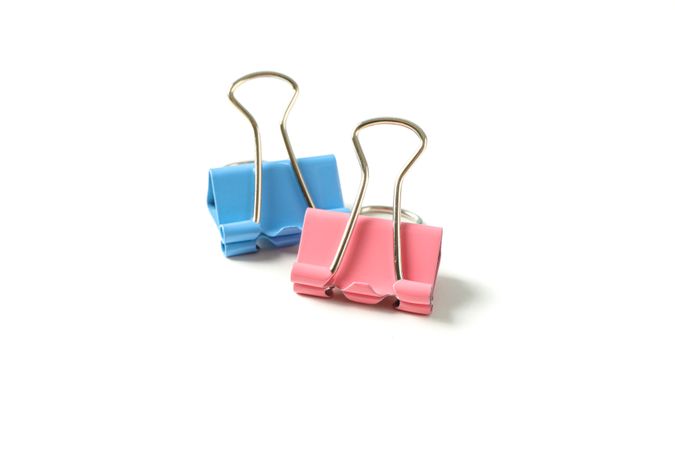 Color paper clips isolated on studio background