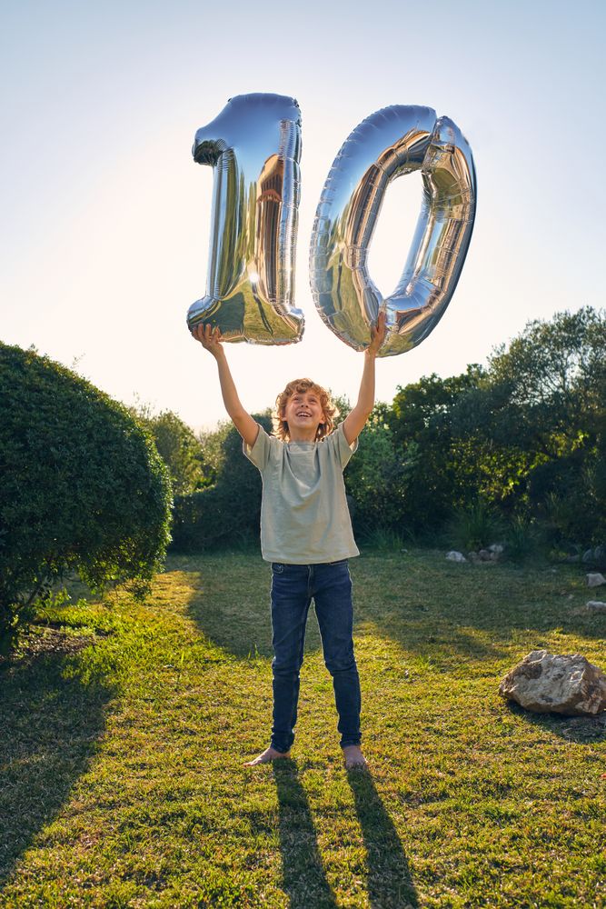 Happy boy with balloon number 10