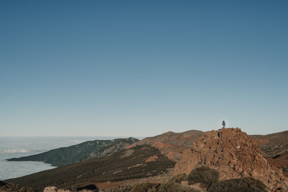 Tourist standing on top of hill