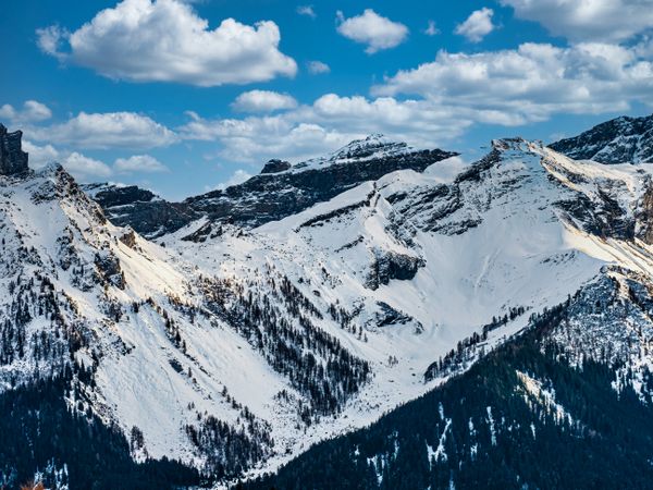 Swiss Alps winter landscape with snow and sun, mountains in Europe