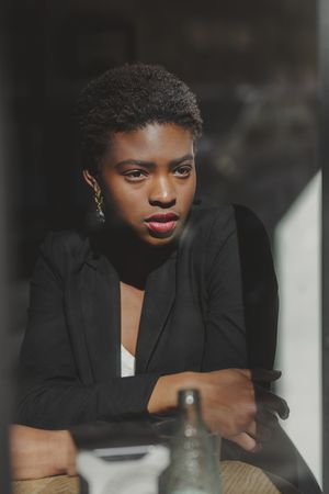 Smiling stylish Black woman in cafe