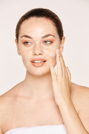 Amiable female taking care of face