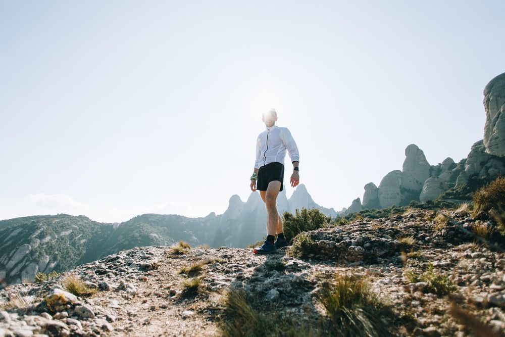 Athletic man standing in nature on warm day