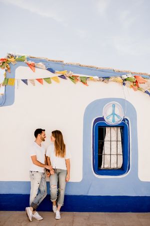 Loving couple cuddling near beach house