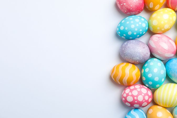 Decorative Easter eggs on neutral background, space for text. Top view
