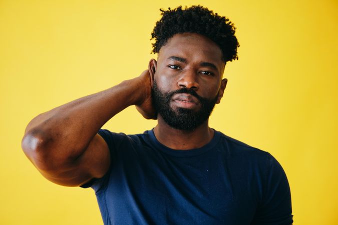 Portrait of Black man with one hand behind his head