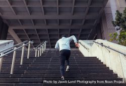 Back view of man running up the stairs bYqG9d