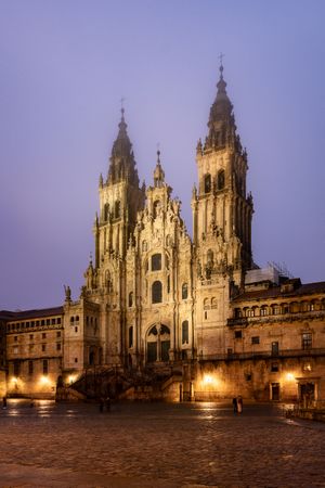 Santiago de Compostela Cathedral view at misty foggy night after rain. Cathedral of Saint James pilgrimage. Galicia, Spain