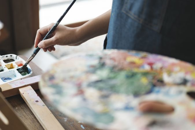 Crafting Inspiration: Female Artist Sketching and Painting in Workshop
