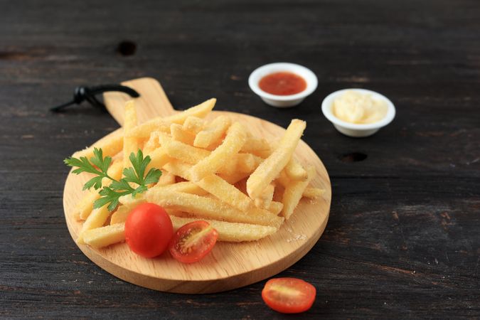Close Up Crispy French Fries on Wooden Plate