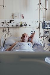 Older man admitted to a hospital room.