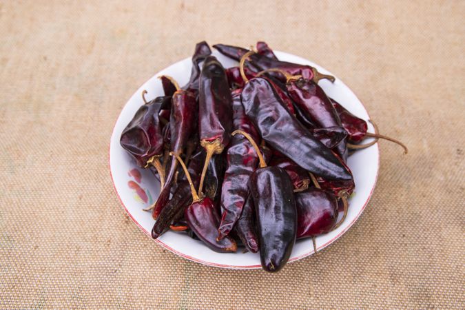 One bowl of Dry Pepper or red chili on the jute fiber fabric