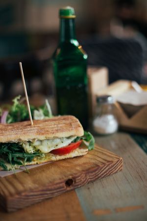 Grilled sandwich on rustic wooden board