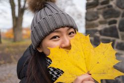 Cheerful young Asian female traveler enjoying sightseeing in Oslo