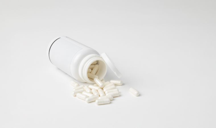 Mockup of a bottle of medicine capsules, or food supplement, lying down