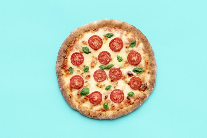 Vegetarian pizza above view, minimalist on a blue background